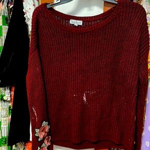 Maroon, long sleeve sweater with roses on the sleeve size medium